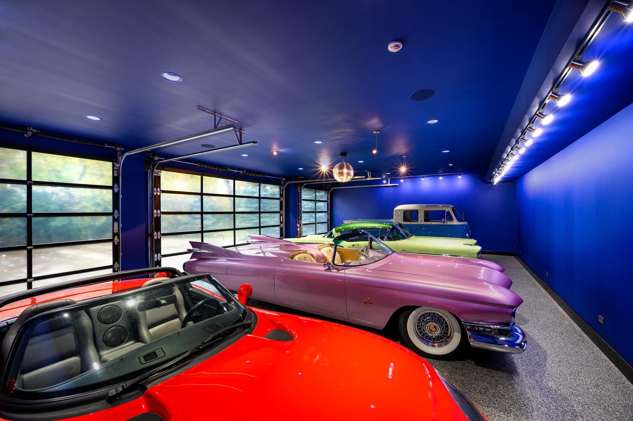 The completely finished upper level 4-car garage features insulated glass garage doors, extensive lighting and a
disco ball. The ceiling height is set to allow for lifts which doubles the vehicle capacity from 4 to 8.