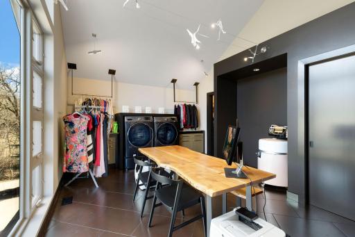An enormous walk-in closet with floor to ceiling windows and unique features throughout leads
to a spacious dressing room and large laundry room with flex space for crafts or storage.