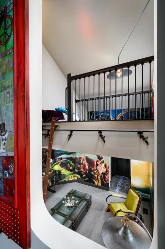 The second of three 2nd floor bedrooms has a unique sliding window opening to the grand stairway.
