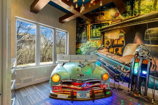 The inspiring main level office has custom, lighted, built-in cabinetry, exposed beams and a one-of-a-kind,vintage car desk with a horn that sounds along with the doorbell.