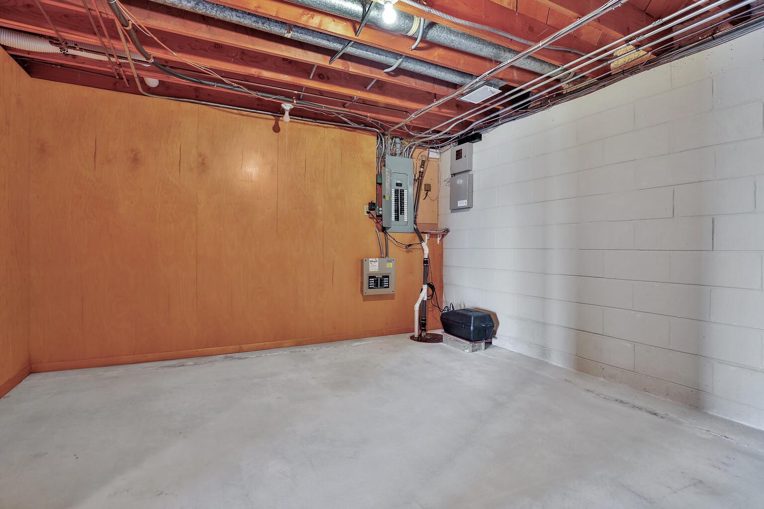 Basement storage room with battery back up sump pump and wiring for Back up house generator.
