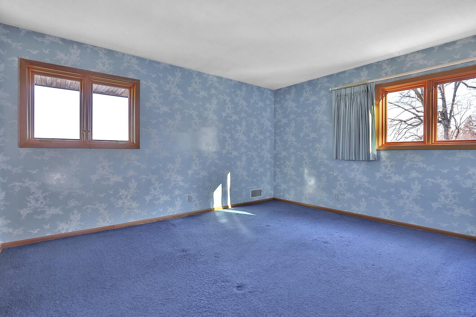 Second of the two main floor bedrooms. Wall coverings from an Era in history.