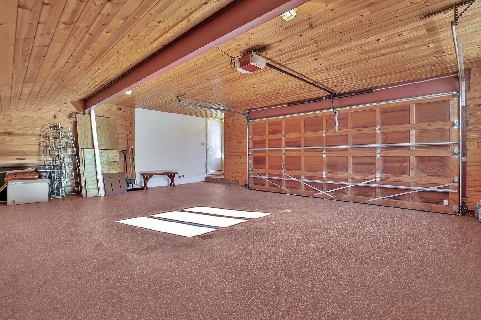 Another view of the garage, left of the roll up door is the exterior door as well as the door into the kitchen.