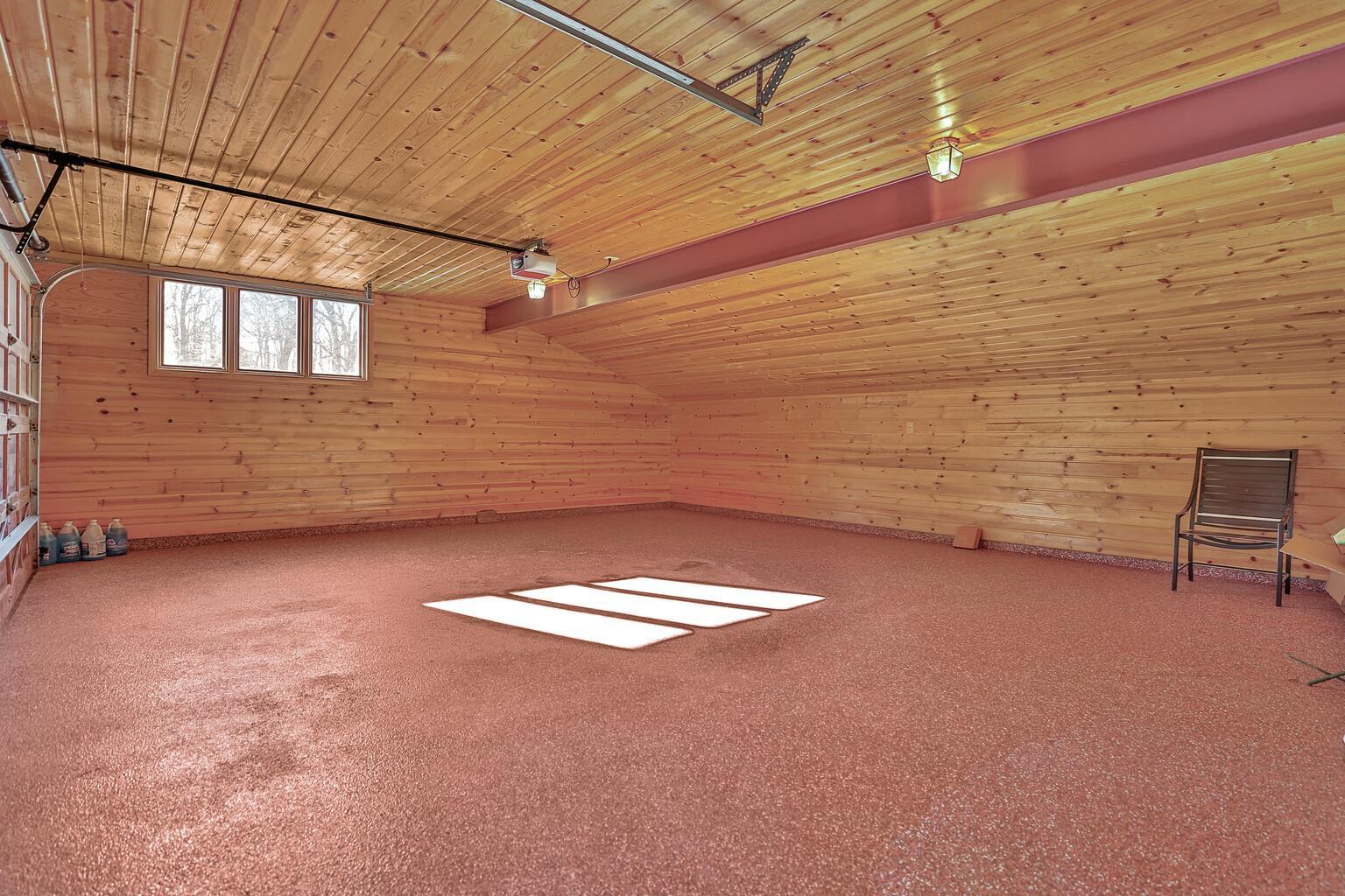 Wood lined attached garage.