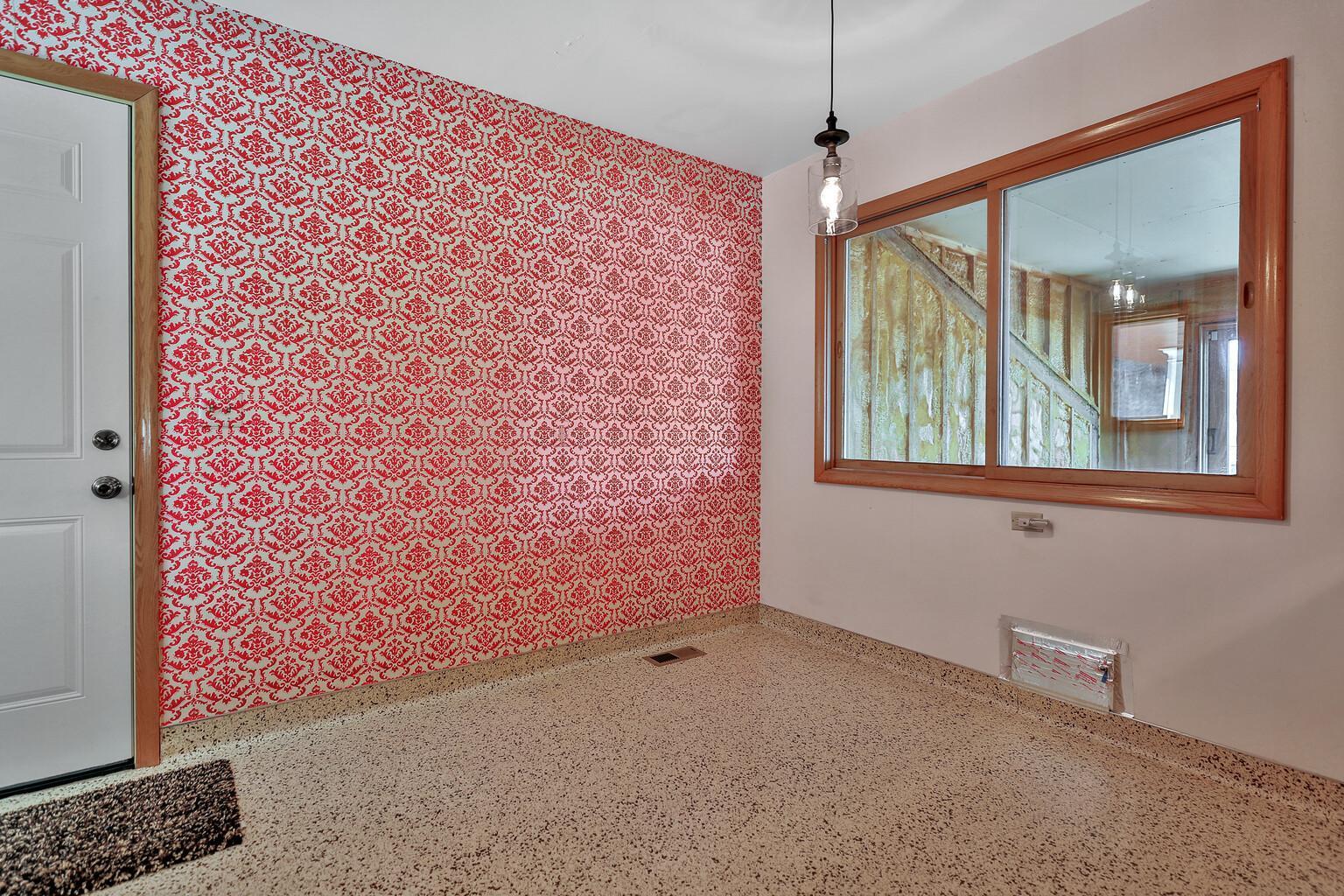 Windows provide the view to the finished shell that is spray foam insulated. Plans for removing the wall and doubling the size of the kitchen ceased shortly after the exterior was completed.