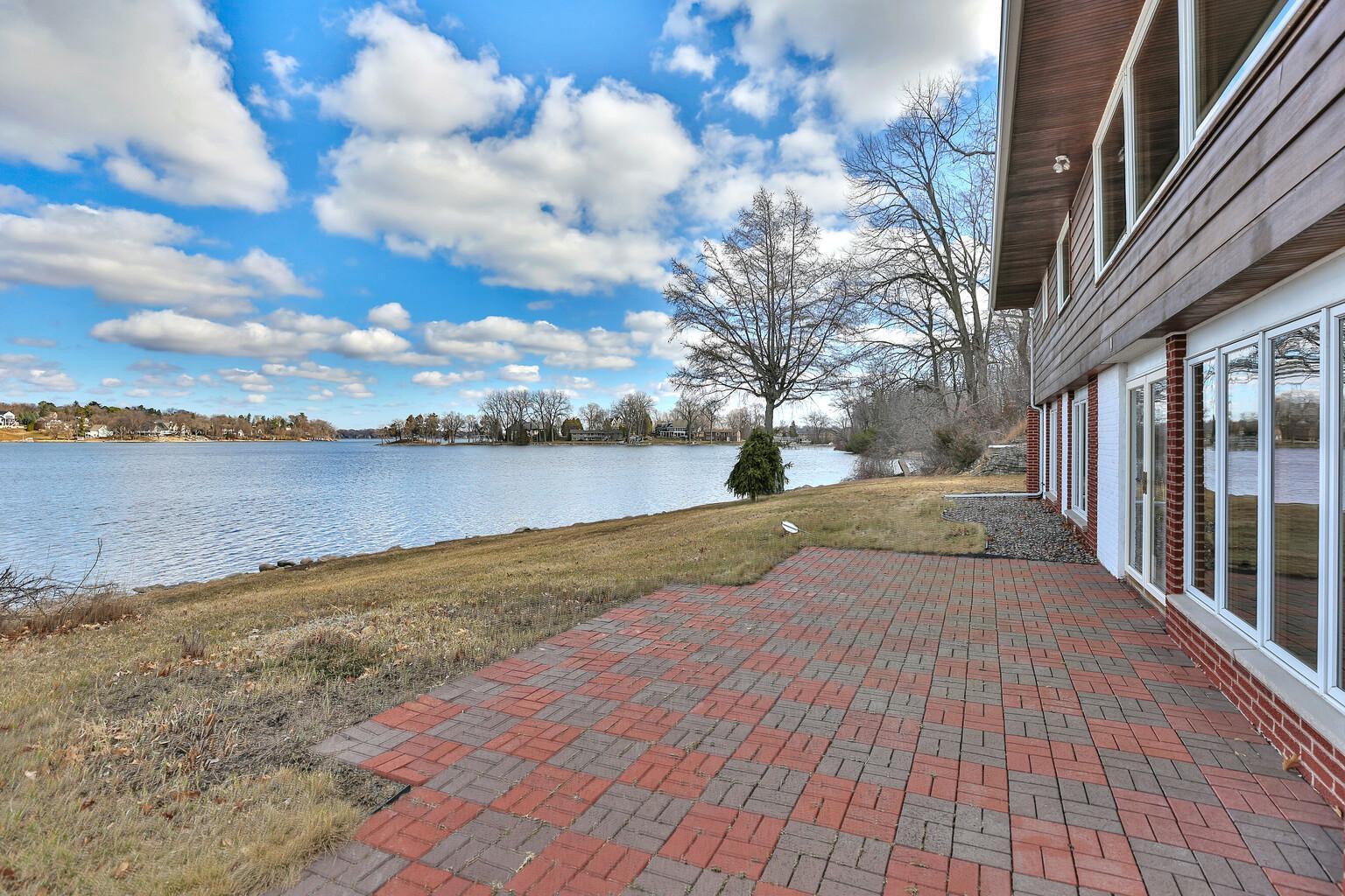 Paver patio and gradual sloping lawn to the water front.