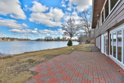 Paver patio and gradual sloping lawn to the water front.