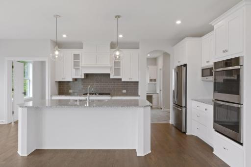 Our gourmet kitchen defines how the WOW comes standard. With a huge center island, granite countertops, gas cook top, and double ovens, plus so much more! (pic of previous model)