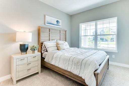 Highly sought after on the main level, this bedroom offers a room for overnight guest. Complete with a private full bath, it is just a perfect addition to the floor plan! Photo of model home, color and options will vary.