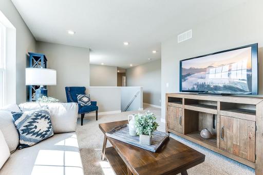 The entire level flows from the focal point offered by this huge loft space. Sure to become a family favorite hangout spot, the room is just steps from each of the home's three upper level bedrooms! Photo of model home, color & options will vary.