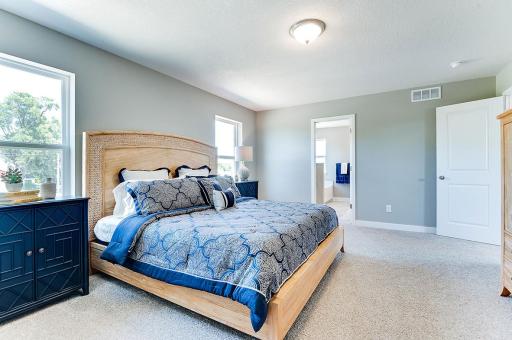 A second view of the Primary Suite. Shown here with a King-sized bed, the room is overly spacious and offers the perfect setting to start and finish each day in! Photo of model home, color and options will vary.