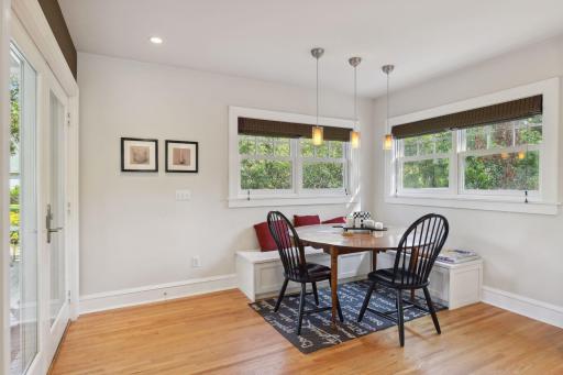 There is an informal dining / gathering area off the kitchen with a built-in corner booth style seat and oversized windows overlooking the private back yard.