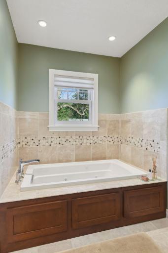 There is a separate tub and shower, this large tub is set in a cozy alcove.