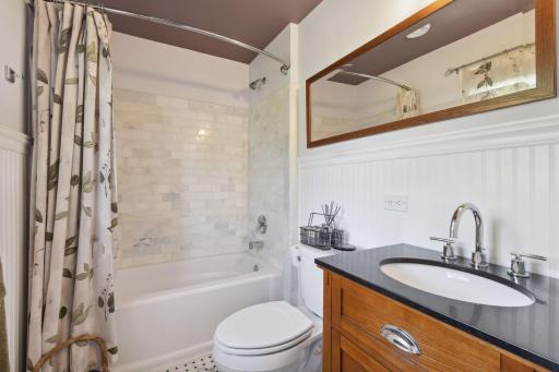 There is a full upper bath that has custom tilework and fixtures.