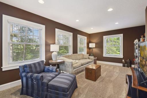 Wrapped in oversized windows, the family room brings in the natural views of the wooded setting outside.
