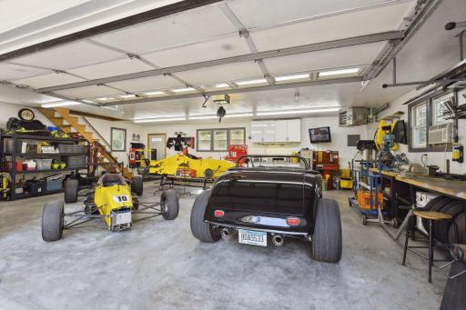 This garage workshop is truly built to be used as a shop for getting things done year round. Heated and cooled and plumbed, plus expansive lighting and a lot of space to work.