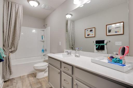 Convenience for the kids too, as the home's upper level guest bathroom features an extra long vanity and linen cabinet. Photo of model home, color and options will vary.