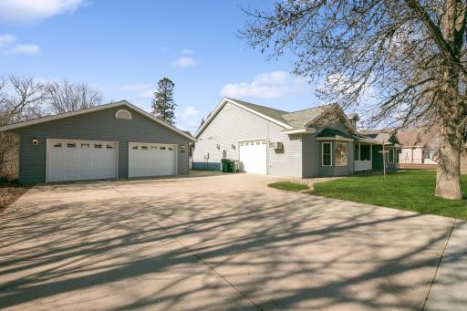Detached 2 car garage and an attached single car garage and concrete driveway and sidewalks!