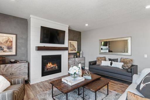 The cozy fireplace is certain to help keep you warm during cold Minnesota winters. (*Photo of decorated model, actual homes colors and finishes will vary)