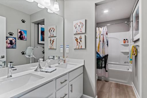 The home's secondary bath features a double-vanity to help keep everyone moving during those busy mornings. (*Photo of decorated model, actual homes colors and finishes will vary)