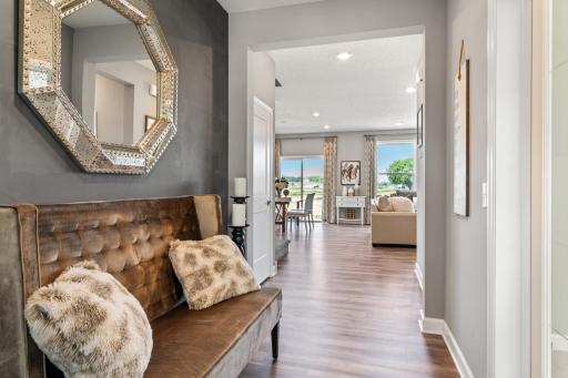 The impressive open foyer area gives the home an elegant entry without sacrificing square footage. (*Photo of decorated model, actual homes colors and finishes will vary)