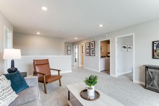 BONUS SPACE! At the top of the stairs you will find a huge loft! This second entertainment space is perfect for a private space or even a friendly get together. *photo of model home