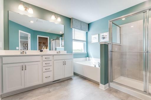 The spa-like primary en-suite brings relaxation after a long day! *photo of model home