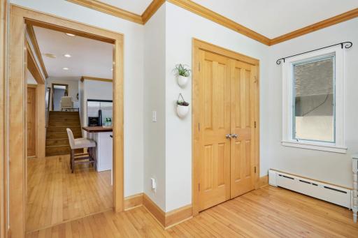 Welcoming entryway with huge coat closet. Notice the beautiful original hardwood floors throughout the main level.