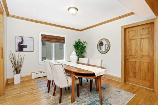 Dining room is open to both the living room and the kitchen - a rare find in a house of this style and vintage! Don't miss the main floor laundry room, located through the door on the right.
