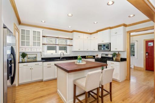 You'll love the updated kitchen! Features custom cabinetry, stainless steel appliances, and a center island. This space will surely become the heart of your new home.