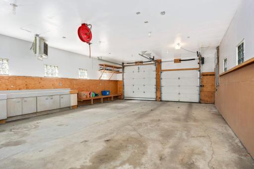 Back downstairs and through the kitchen you'll find an attached 4 car garage (tandem) with oversized garage door. A rare find in the city! Space for multiple vehicles, a boat, or a large workshop