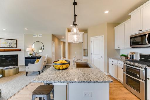 Kitchen has ample counter space (including seating at the island!) and lots of cabinet space. The perfect space for making everyday meals or memorable special occasion dinners. *Photo of previous model. Actual home may vary.