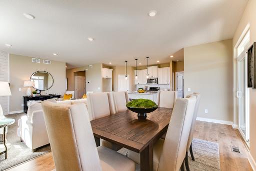 Grab a meal at the island, or utilize this dining space - which features plenty of natural light to stream into the space and overlooks the home's covered patio! *Photo of previous model. Actual home may vary.