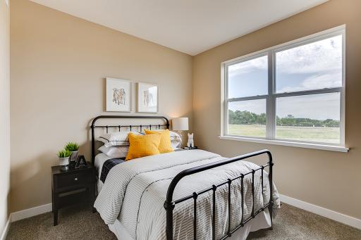 On the opposite side of the home from the primary suite you'll find two bedrooms and full bath! *Photo of previous model. Actual home may vary.