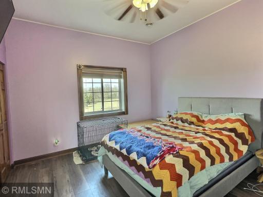 Turn-in for the night with a large bedroom offering laminate flooring, ceiling fan, window and large closet.