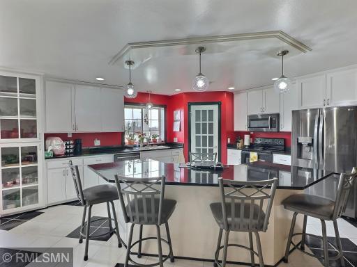 The kitchen includes an island for excellent entertaining and prep, custom cabinets, and walk-in pantry.