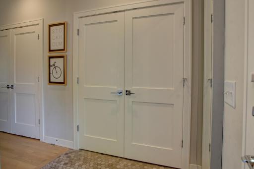 Mud room with closets and convenient storage.