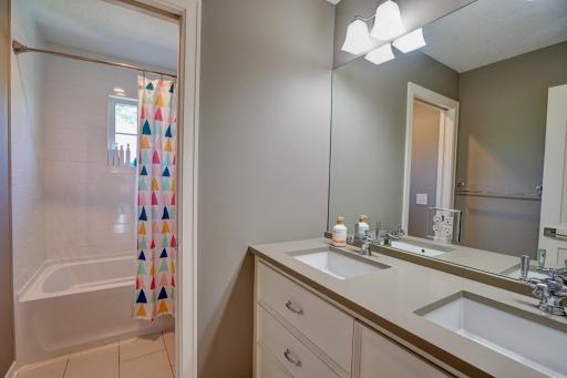 Upper level full bath with tub/shower and dual sinks.