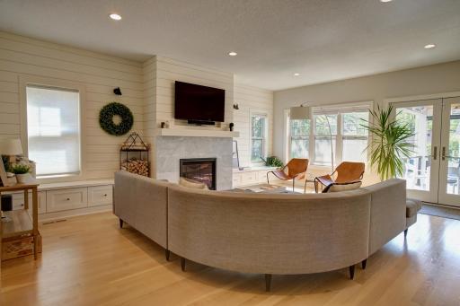 Large family room space featuring Heat-n-Glo fireplace, mantel and smart-lighting.