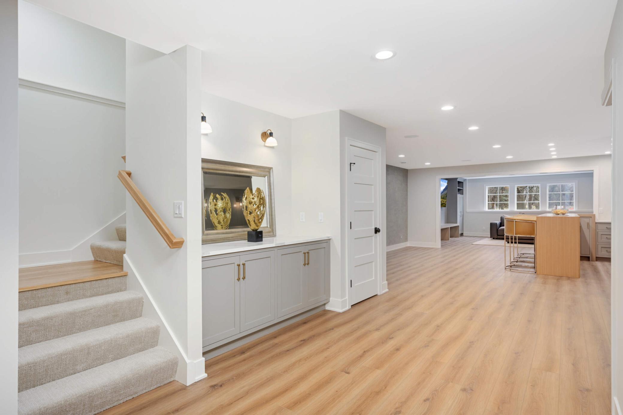 Lower level with full custom bar and luxury vinyl plank flooring