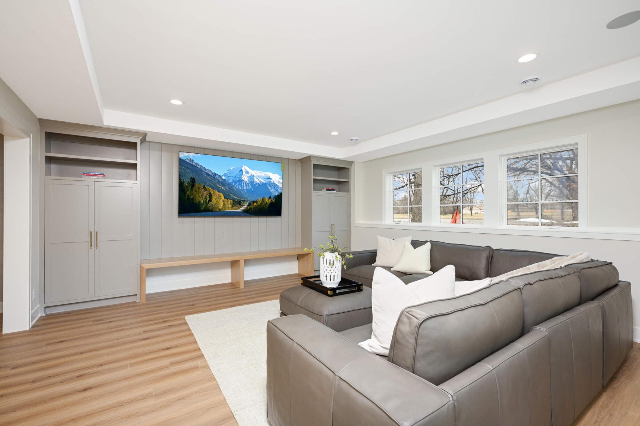 Large lower level family room with custom cabinetry