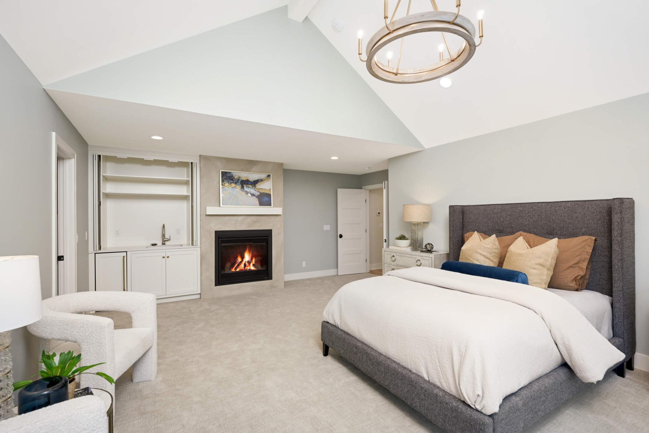The primary suite has a full white bar, beverage, fridge, and fireplace