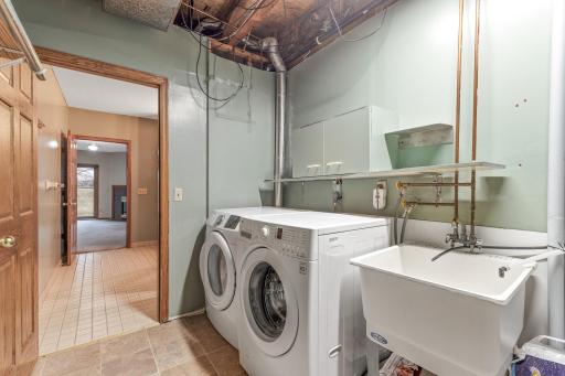 Laundry room features modern front-load machines.