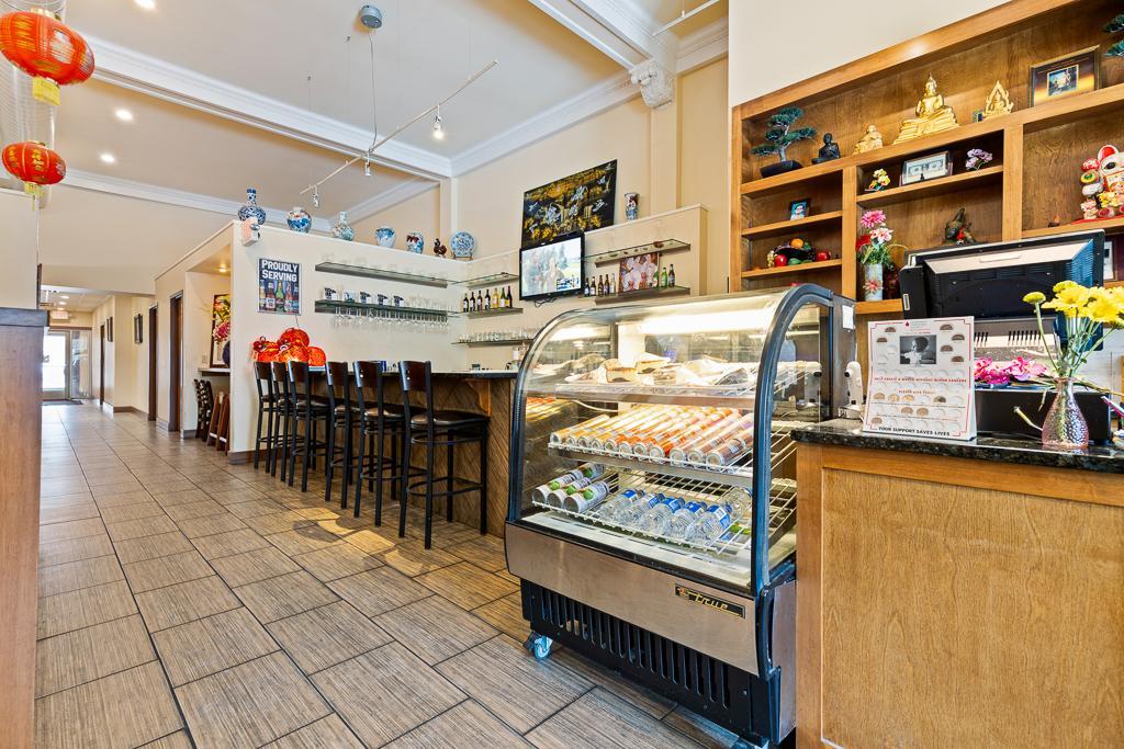 The entrance also brings patrons by a display cooler full of desserts and beverages, as well as the bar seating area