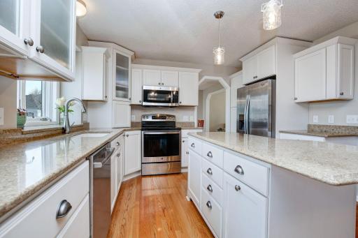 Solid surface countertops, newer light fixtures, stainless steel appliances and large center island create a destination.