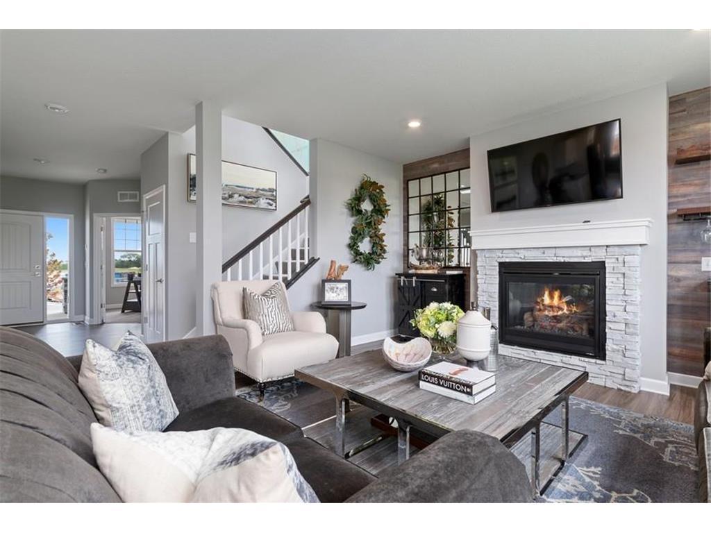 (Photo of a decorated model, actual homes finishes will vary) Cozy and large Great room a perfect place to enjoy a nice fire.