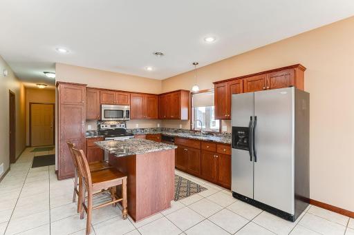 Center Island, Stone Countertops and Stainless Steel Appliances