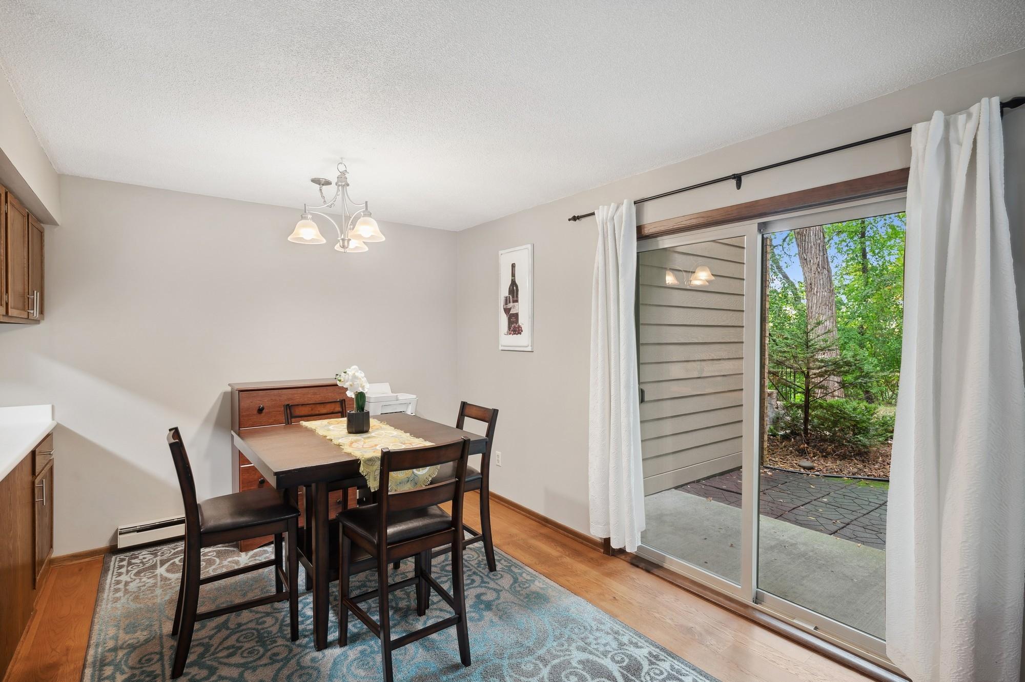 Dining room with sliding door to patio and views of the woods/wetlands.