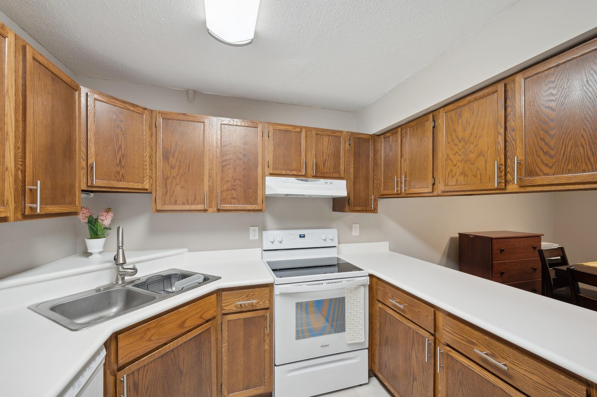 Kitchen with newer appliances and counters has plenty of storage.