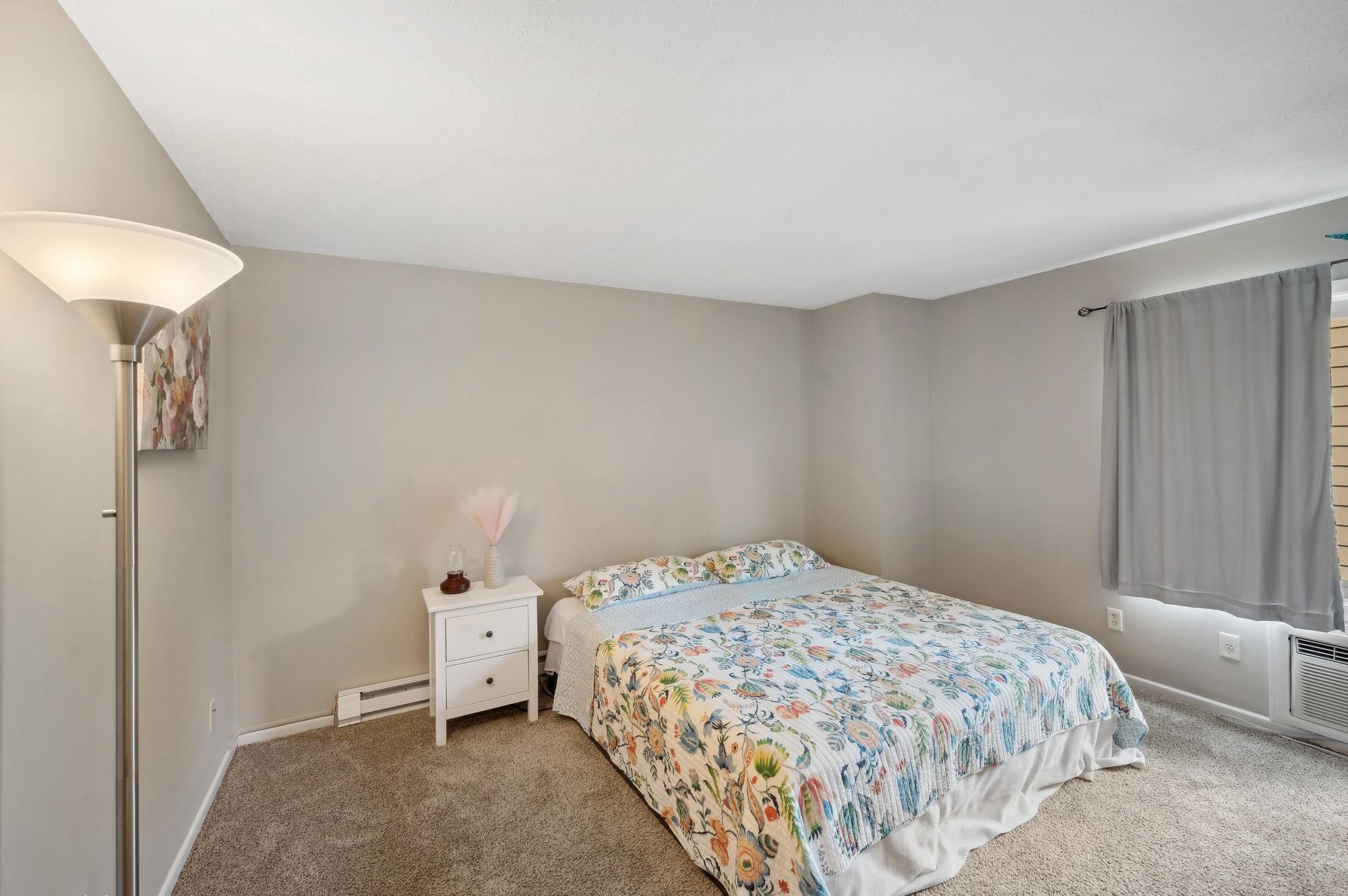 Spacious primary bedroom with a walk in closet.